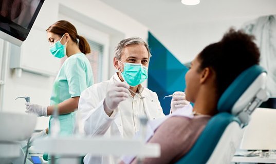 Dentist treats patient