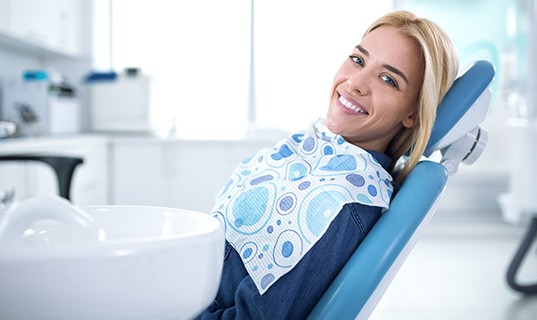 Smiling woman sitting in dental office