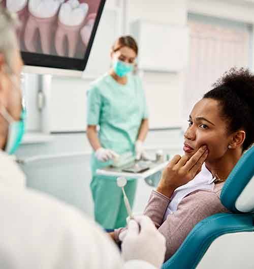 Woman with tooth pain at the dentist